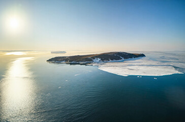 Aerial view of ice hummocks and icebergs in Arctic ocean.