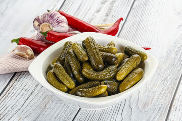 Marinated small cucumbers in the bowl