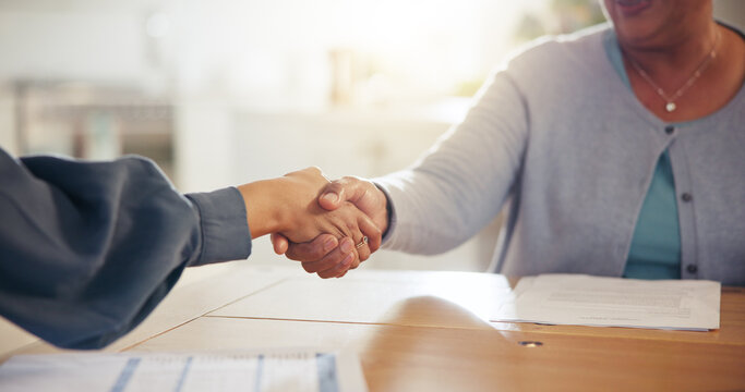 People, handshake and meeting for retirement plan, documents or paperwork in deal or insurance at home. Closeup of senior woman shaking hands with attorney or lawyer for legal agreement at house