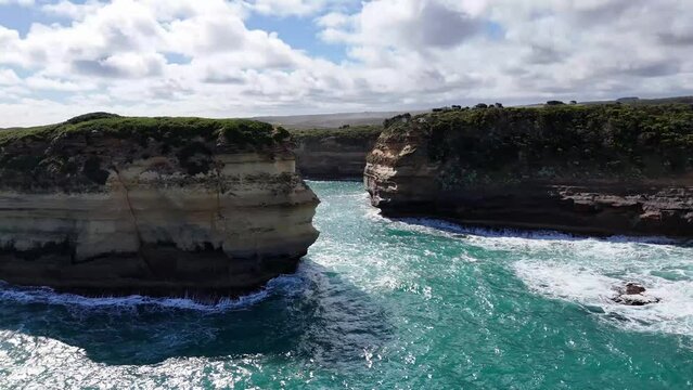 Aerial views of the 12 Apostles, limestone stacks along the Great Ocean Road in Victoria, Australia. Dramatic cliffs, turquoise waters, and crashing waves. Australia's most popular tourist destination