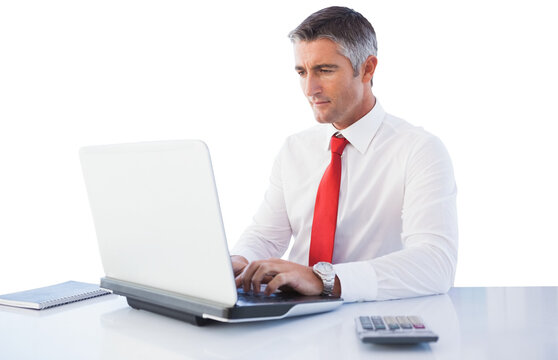 Digital png photo of caucasian businessman using laptop at desk on transparent background