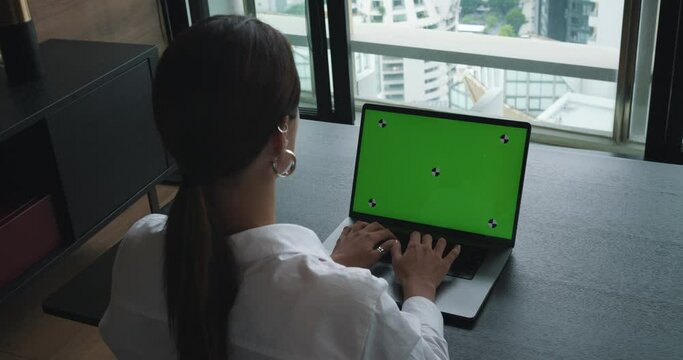 Close up of a woman's hands working on green screen on a laptop scrolling, surfing web. female specialist works online on laptop computer with mock up green screen. concept work online