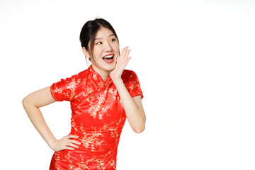 Asian woman wearing traditional cheongsam qipao dress with gesture shouting and holding palm near...