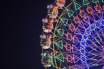 a colorful glowing big swing in the fair