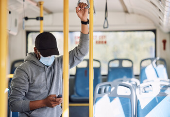 Man in bus with mask, phone and reading on morning travel to city, checking service schedule or social media. Public transport safety in covid, urban commute and person in standing with smartphone. - obrazy, fototapety, plakaty