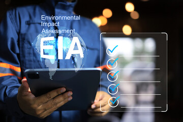 EIA environmental impact assessment concept with engineer holding tablet and check item list to comply requirement environmental regulation