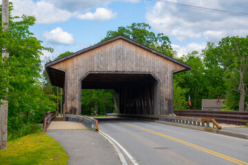Fototapeta na wymiar Pepperell Covered Bridge across Nashua River near historic town center of Pepperell, Massachusetts MA, USA. 