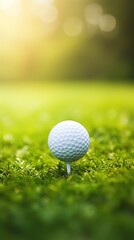Obraz premium Close up photo of a golf ball on tee with blurred green bokeh background. Perfect for use in golf related advertising, social media posts, or website designs.