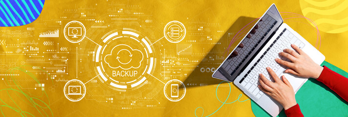 Backup concept with person using a laptop computer