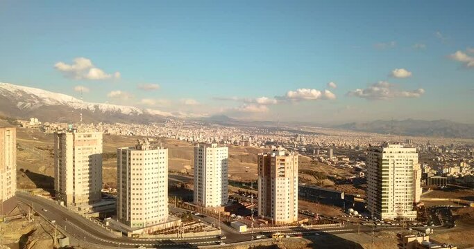 aerial fly drone shot over Tehran city of light air pollution and revolution people unrest arrest by police guard  in woman life freedom movement protest today tonight view landscape of tower people