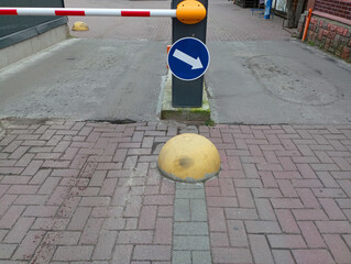Entrance to paid parking. A closed barrier, at the entrance of which there is a sign indicating the...