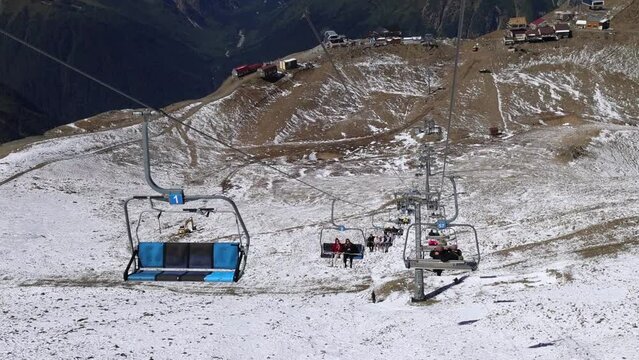 Funicular railway, Climb up the mountain, ride down the cable car, Dombay ski resort, empty seats above snow covered mount