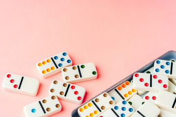 Domino tiles on pink background studio shot