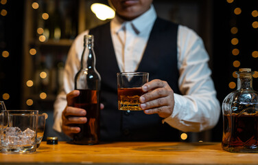 Barman pouring whiskey whiskey glass..