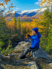 A boy on the background of an autumn Arctic landscape in the Khibiny mountains. Kirovsk, Kola...