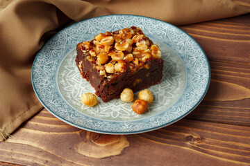 Brownie cake with chocolate and hazelnuts on plate