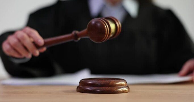 Judge knocks with wooden gavel in courtroom