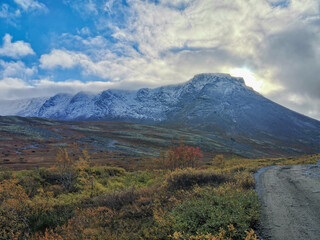 Autumn Arctic landscape in the Khibiny mountains. Kirovsk, Kola Peninsula, Polar Russia. Autumn colorful forest in the Arctic, Mountain hikes and adventures.