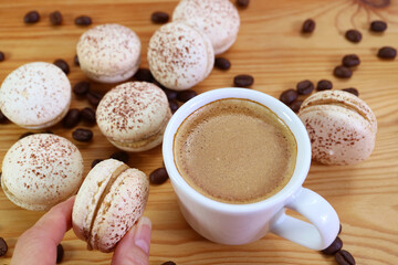 Closeup of a Cup of Hot Espresso Coffee with Heap of Delectable Tiramisu Macarons