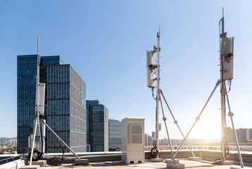 Mobile communication base station on the rooftop - obrazy, fototapety, plakaty