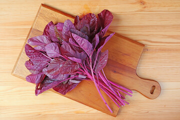 Fresh Organic Red Spinach or Amaranthus Dubius on Wooden Chopping Board