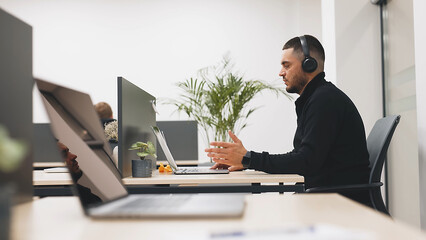 Blogging, live broadcasting of events with subscribers. A young man in wireless headphones has a conversation with a client, friend or subscribers via video call, has a business or personal conversati