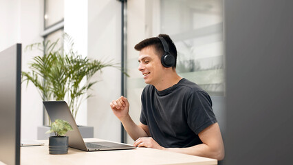 Blogging, live broadcasting of events with subscribers. A young man in wireless headphones has a conversation with a client, friend or subscribers via video call, has a business or personal conversati