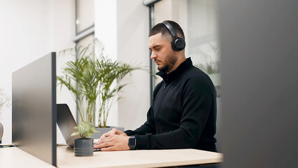 Blogging, live broadcasting of events with subscribers. A young man in wireless headphones has a conversation with a client, friend or subscribers via video call, has a business or personal conversati