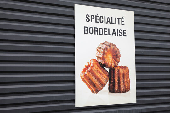 Local French text specialite bordelaise means Bordeaux specialty city dessert canele on advertising background