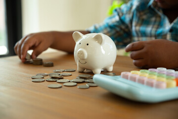 Little African boy with calculator for calculations, Developing skills, Learning, Saving money concept.