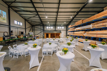 Decorated white tables in industrial premises, seminar, conference