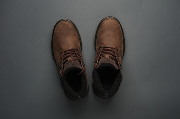 Leather boots on dark gray background. Top view