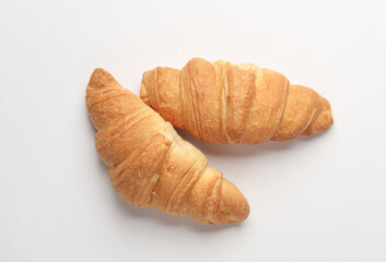 Two appetizing croissants on a white background