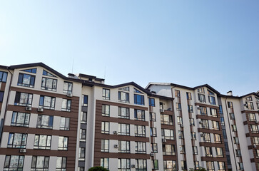 Modern apartment buildings on a sunny day with a blue sky. Facade of a modern European apartment building