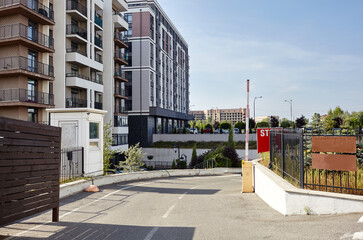 Road to buildings parking. Automatic barrier, entrance to the parking lot