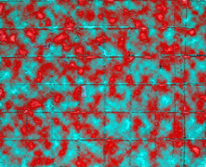 The iron wall of the garage painted with aerosol bolonchiki in red and green dots