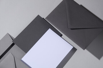 Floating envelopes and card on gray background with shadow. Minimalism, modern business still life, creative layout