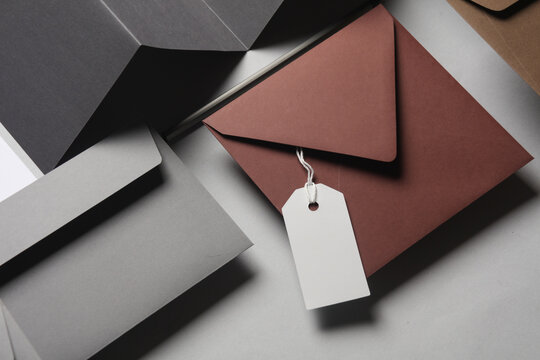 Floating envelopes and brochure, cards, tag on gray background with shadow. Minimalism, modern business still life, creative layout