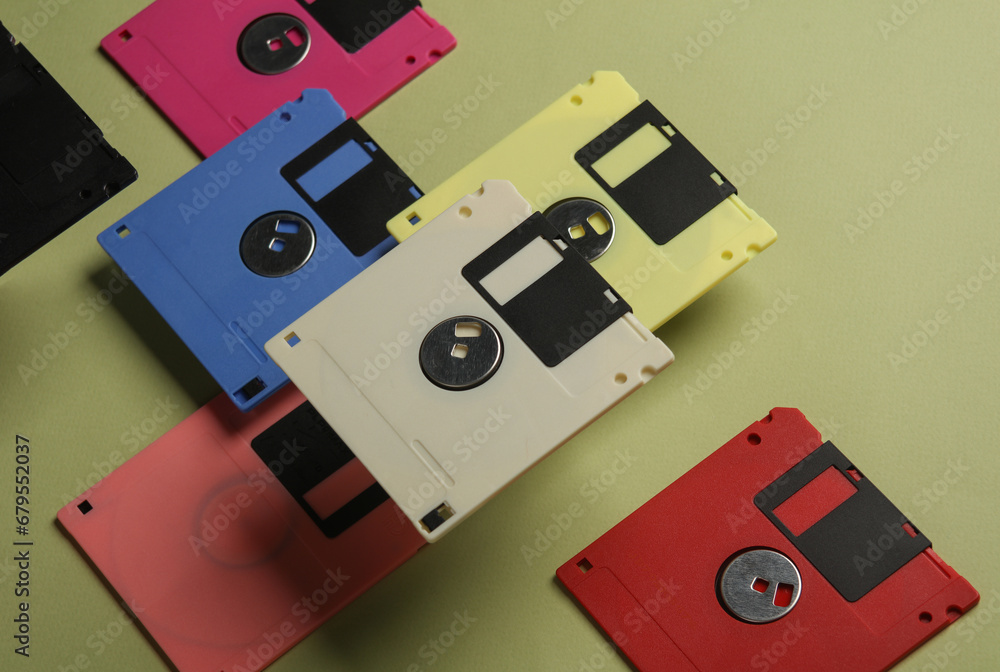 Poster floating colored retro 80s floppy disks on a green background. conceptual pop, creative layout