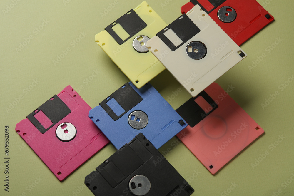 Poster floating colored retro 80s floppy disks on a green background. conceptual pop, creative layout