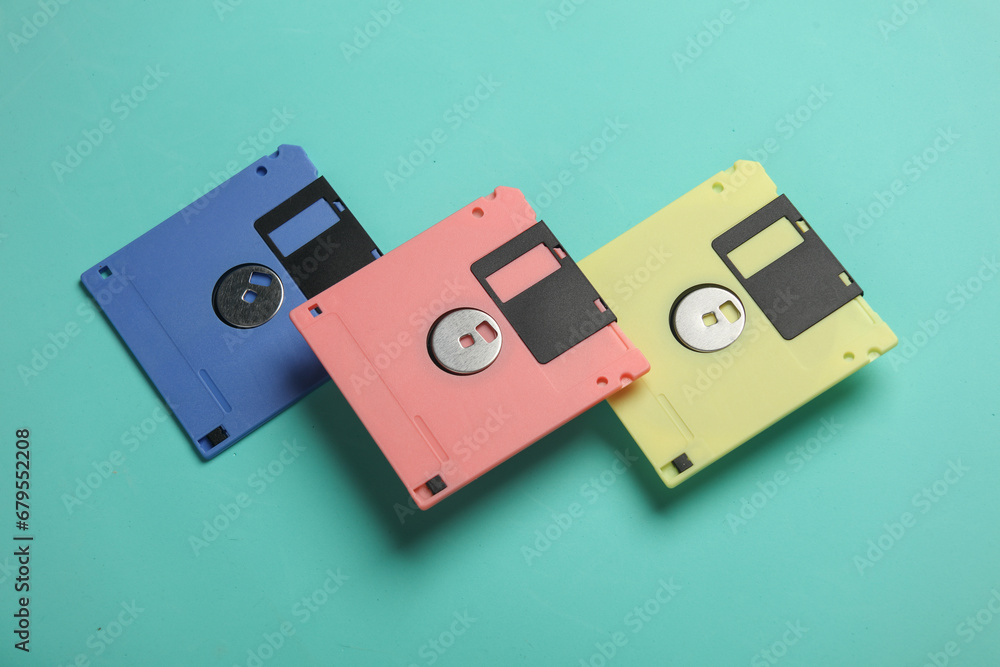 Poster floating colored retro 80s floppy disks on a blue background. conceptual pop, creative layout