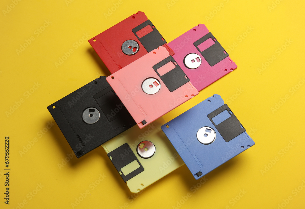 Poster floating colored retro 80s floppy disks on a yellow background. conceptual pop, creative layout