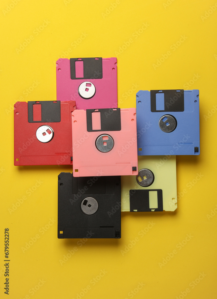 Poster floating colored retro 80s floppy disks on a yellow background. conceptual pop, creative layout