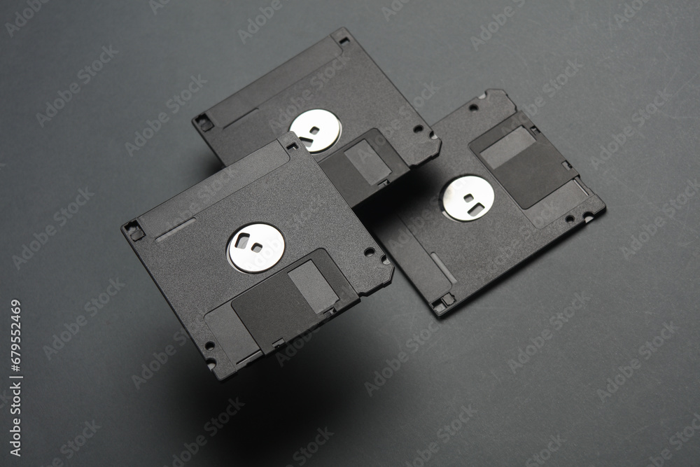 Poster floating colored retro 80s floppy disks on dark gray background. conceptual pop, creative layout