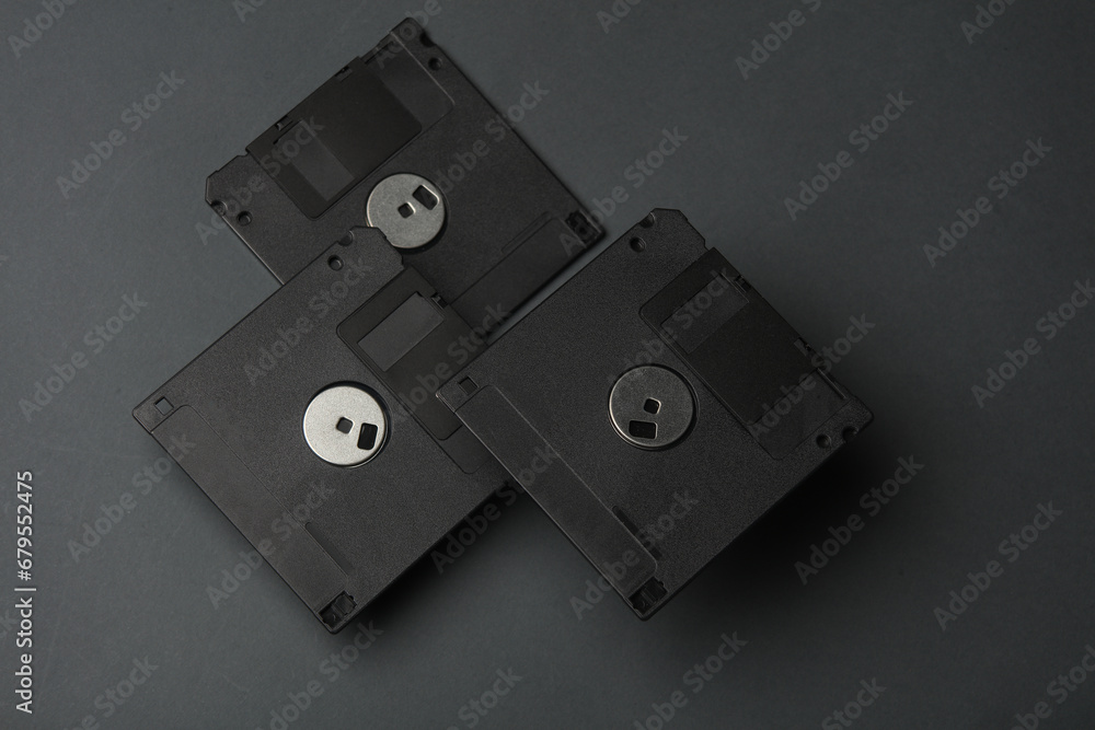 Poster floating colored retro 80s floppy disks on dark gray background. conceptual pop, creative layout