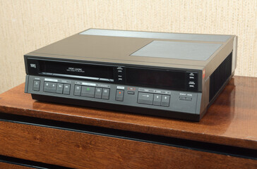 Fototapeta premium An old vintage VCR from the 1980s sits on the nightstand.