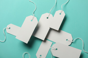 Composition of floating white price tags on blue background. Creative layout