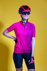 Winsome Sexy Positive Female Road Cyclist in Professional Shot Sleeve Jersey Outfit Posing Against Yellow
