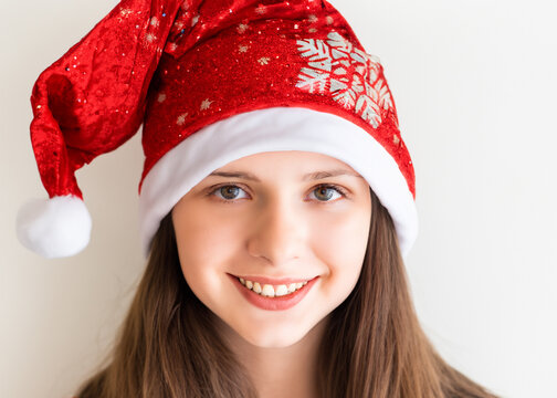 クリスマスのイメージの人物写真、サンタクロースの帽子をかぶった若い笑顔の女性