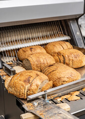 Sourdough bread slicing in industrial bread slicing machine